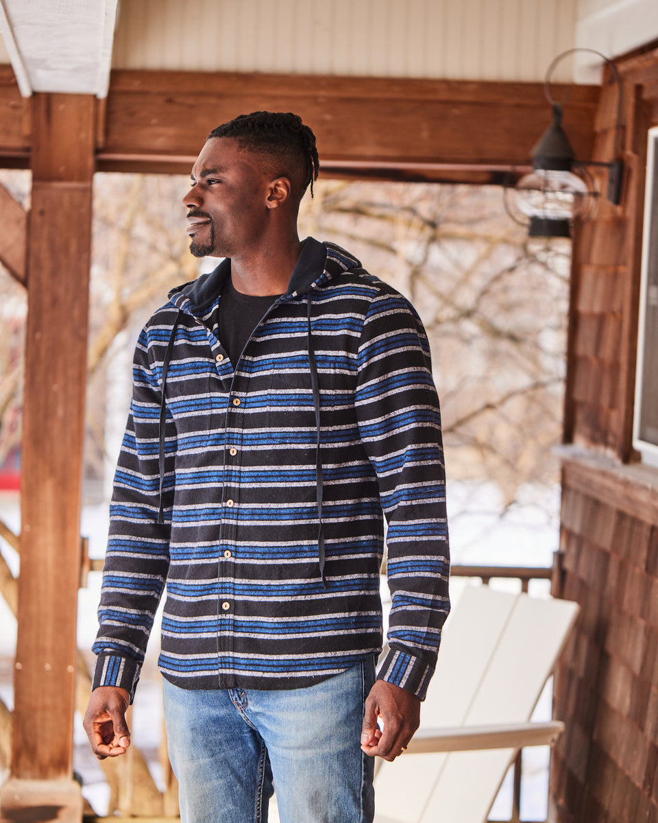 Man in Blue and White Plaid Shirt and Denim Jeans Standing on